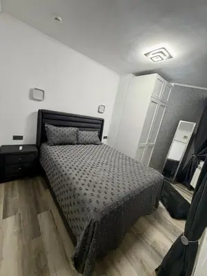 a bedroom with a bed in a white room at Flora Residence Cozy Apartments in Borovets