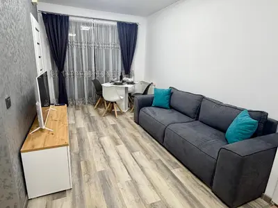 a living room with a couch and a table at Flora Residence Cozy Apartments in Borovets