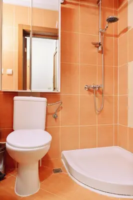 a bathroom with a white toilet and a shower at GOLF Queen MARIA Apartment Home2Host in Razlog