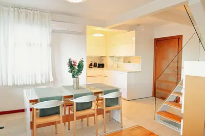 a kitchen and dining room with a table and chairs at GOLF Queen MARIA Apartment Home2Host in Razlog