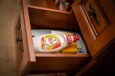 a cabinet with a bottle of mayonnaise and towels at Bansko Peak Apartments 304 in Bansko