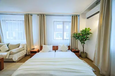 a bedroom with a large bed and a couch at Bansko Peak Apartments 304 in Bansko