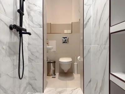 a small bathroom with a toilet and a shower at Cozy Central 1BD Apartment in Sofia