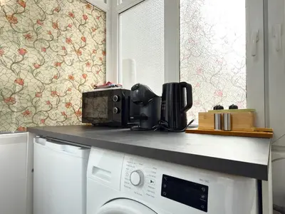a washing machine in a kitchen with a counter top at Cozy Central 1BD Apartment in Sofia