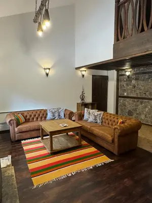 a living room with two couches and a coffee table at Къща за гости Пампорово в махала Кочорите in Pamporovo
