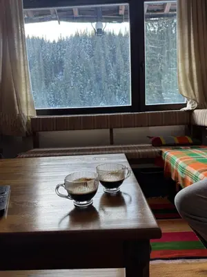 two cups on a table in a room with a window at Къща за гости Пампорово в махала Кочорите in Pamporovo