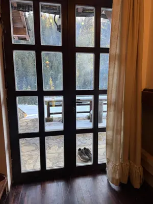 a door with four glass windows and shoes outside at Къща за гости Пампорово в махала Кочорите in Pamporovo