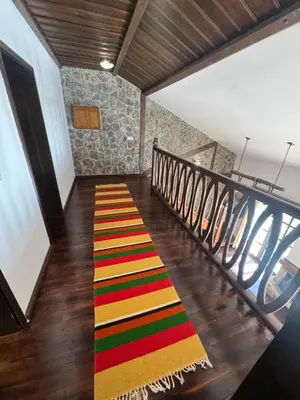 a staircase with a colorful rug on the floor at Къща за гости Пампорово в махала Кочорите in Pamporovo
