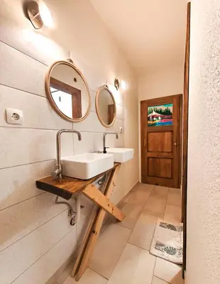 a bathroom with a sink and a mirror on the wall at PORTALA Urban Lodge in Rila