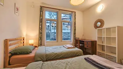 a bedroom with two beds and a window at PORTALA Urban Lodge in Rila