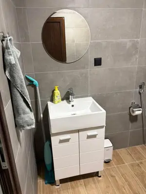a bathroom with a white sink and a mirror at Парксайд Лейн Студио in Bansko