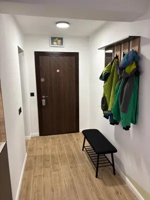 a hallway with a room with a door and a stool at Парксайд Лейн Студио in Bansko