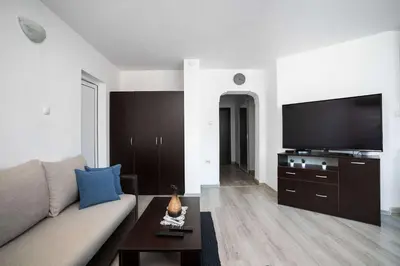 a living room with a couch and a flat screen tv at Sunny & Modern 1BR Apartment in Sofia