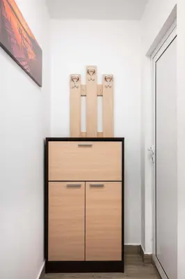 a dresser in a room with two baseball bats at Sunny & Modern 1BR Apartment in Sofia