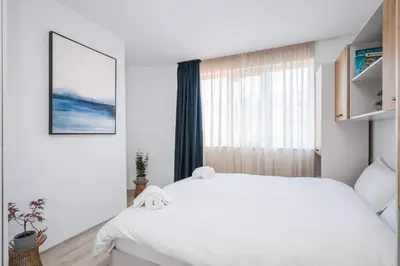 a bedroom with a white bed and a window at Sunny & Modern 1BR Apartment in Sofia