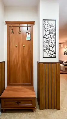 a wooden door with a cabinet and a picture on the wall at Bansko Peak Apartments 508 in Bansko