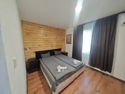 a bedroom with a bed with two towels on it at Свети Георги in Tsigov Chark
