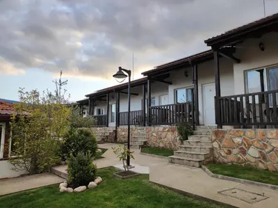 a house with a stone wall and a street light at Свети Георги in Tsigov Chark