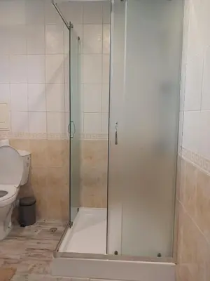 a shower stall in a bathroom with a toilet at Monfort Studio in Bansko