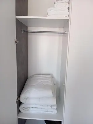a white closet with white towels in it at Monfort Studio in Bansko