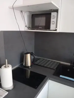a tea kettle on a stove in a kitchen at Monfort Studio in Bansko
