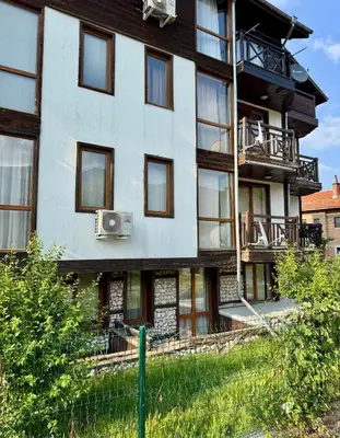 an apartment building with a speaker in front of it at Yeti Complex in Bansko