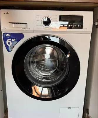 a white washing machine with its door open at Yeti Complex in Bansko