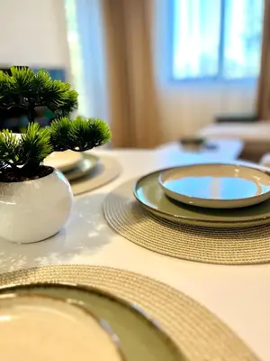 a table with plates and a potted plant on it at Pamporovo Cozy Ski-Close Nest in Pamporovo