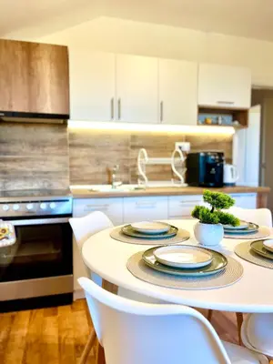 a kitchen with a table with plates on it at Pamporovo Cozy Ski-Close Nest in Pamporovo