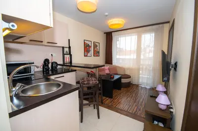 a kitchen with a sink and a living room at Private Ap in Perun Lodge Ski Escape & Spa in Bansko