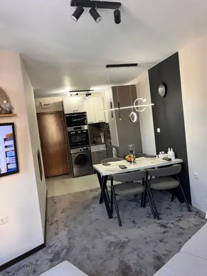 a kitchen with a white table in a room at Elizi2 winter apartments Pamporovo in Pamporovo
