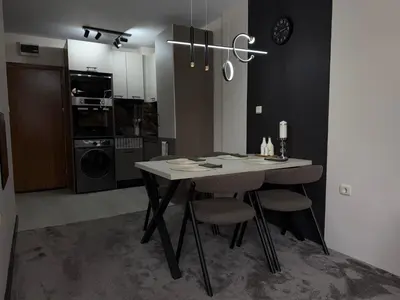 a kitchen with a table and chairs in a room at Elizi2 winter apartments Pamporovo in Pamporovo
