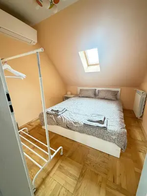 a small bedroom with a bed and a window at New cozy apartment with undefloor heating 86m2 in Sofia