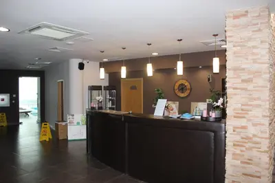 a lobby of a salon with a counter and lights at Comfort apartment in the house in Razlog