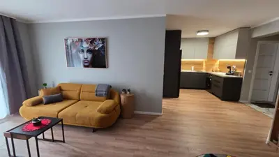 a living room with a couch and a table at By The Pool Apartments #8 in Velingrad