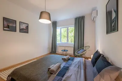 a bedroom with a bed with two pillows on it at Beautiful Bright and Spacious Central Apt in Sofia