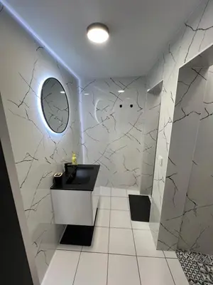 a bathroom with a sink and a mirror at Plovdiv City Apartments in Plovdiv