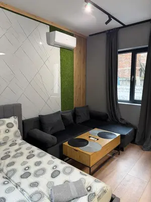 a living room with a couch and a table at Plovdiv City Apartments in Plovdiv
