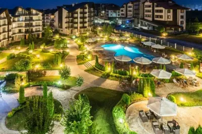an overview of a resort with a pool at night at Aspen Golf Resort Studio E206 in Bansko