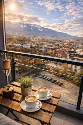 two cups of coffee on a table with a view of a city at Mountain View Escape - Cozy Apt with Private Parking in Sofia