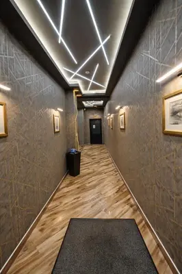 a hallway with a long hallway with a black rug at Mountain View Escape - Cozy Apt with Private Parking in Sofia