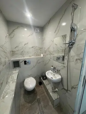 a white bathroom with a sink and a toilet at Berta Gardens 2 in Sandanski