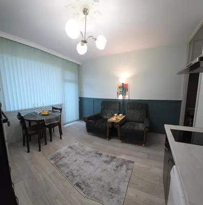 a living room with a couch and a table at ZAKKY STUDIO Cozy Apartment to the City Center and International Fair in Plovdiv