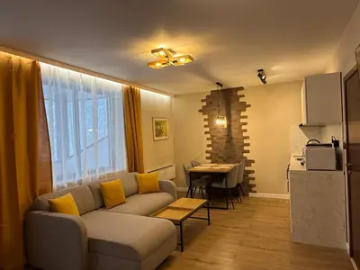 a living room with a couch and a table at Pamporovo Living Cozy Mountain Home in Chepelare