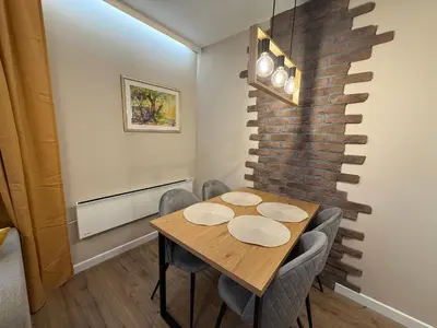 a dining room with a wooden table and chairs at Pamporovo Living Cozy Mountain Home in Chepelare