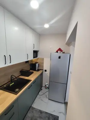 a kitchen with a white refrigerator and a sink at Martin's Apartment in Bansko