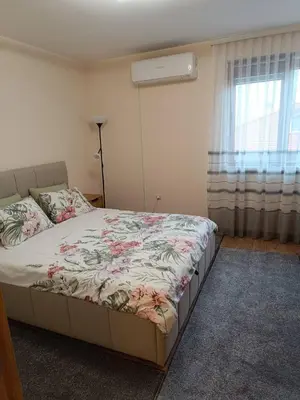 a bedroom with a bed with a floral bedspread at Martin's Apartment in Bansko