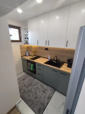 a kitchen with white cabinets and a sink at Martin's Apartment in Bansko