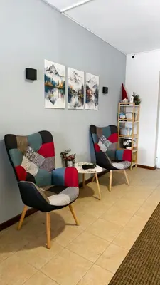 a living room with two chairs and a table at Cozy Stylish 2-bedroom apt near ski road, 5min to Gondola & bars in Bansko