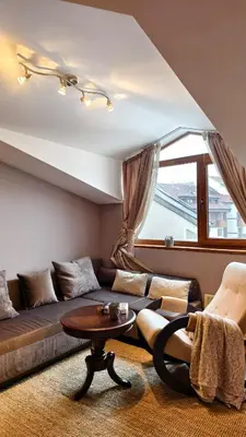 a living room with a couch and a table at Cozy Stylish 2-bedroom apt near ski road, 5min to Gondola & bars in Bansko